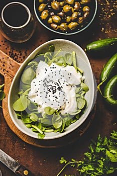 Fresh green purslane salad with yogurt, black sesame and vegetables