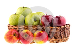 Fresh green and red apples in a wicker baskets