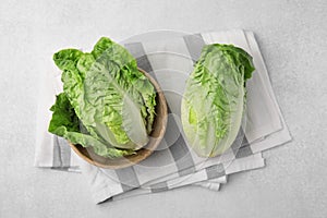 Fresh green romaine lettuces on grey table, flat lay