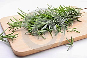 Fresh green rosemary twigs on white wooden table, closeup