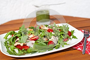 Fresh green salad with rucola tomatoes and grilled chicken