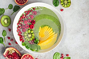 fresh green smoothie bowl with spinach, mango, kiwi and raspberry. Healthy vegan raw food