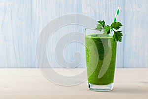 Fresh green smoothie on wooden table