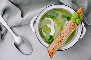 Fresh green soup on grey background