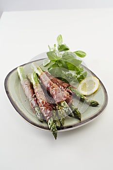 Fresh green spring asparagus spears with ham