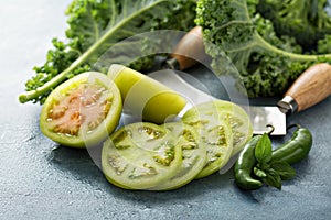 Fresh green tomato cut on the table