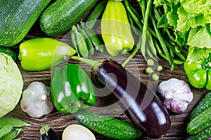 Fresh green vegetables, autumn harvest, on a wooden background