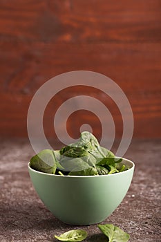 Fresh green vegetables in a bowl and on the table