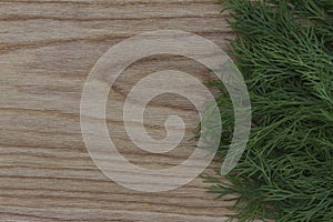 Fresh greens on the background of a wooden kitchen brushed boa