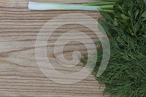 Fresh greens on the background of a wooden kitchen brushed boa