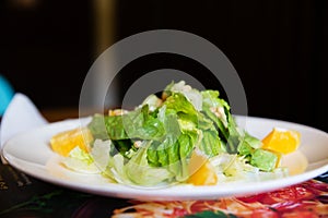 Fresh greens salad on a white plate