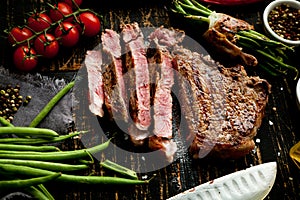 Fresh grilled meat. Grilled beef steak medium rare on wooden cutting board. Top view..