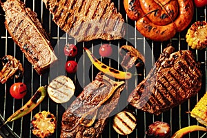 Fresh grilled meat steaks and vegetables on barbecue grate