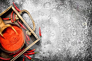 Fresh ground hot pepper in a bowl on a tray.