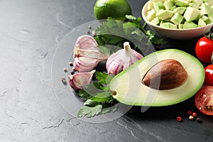 Fresh guacamole ingredients on table. Space for text