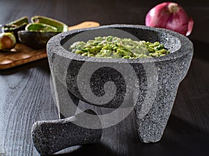 Fresh guacamole in stone molcajete