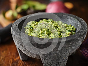 Fresh guacamole in stone molcajete