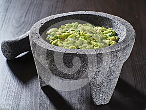 Fresh guacamole in stone molcajete