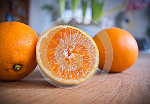 Fresh halfed orange fruit on a wooden table