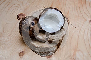 Fresh halved coconut on light wooden background. Organic healthy food concept. Beauty and SPA. Eco nature style. Rustic