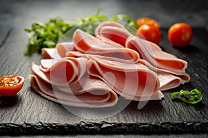 fresh ham slices, over dark background