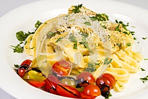 Fresh handmade tagliatelle pasta with forest mushrooms, parsley and cherry tomatoes salad