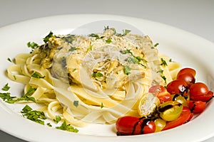 Fresh handmade tagliatelle pasta with forest mushrooms, parsley and cherry tomatoes salad