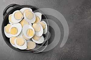 Fresh hard boiled eggs on brown table, top view. Space for text