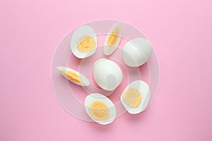 Fresh hard boiled eggs on pink background, flat lay