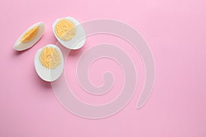 Fresh hard boiled eggs on pink background, flat lay. Space for text