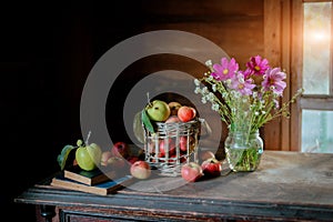 Fresh harvest of ripe and healthy farm apples in a glass jar, in a basket