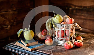 Fresh harvest of ripe and healthy farm apples in a glass jar, in a basket.