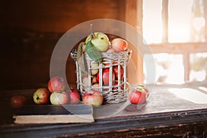 Fresh harvest of ripe and healthy farm apples in a glass jar, in a basket.