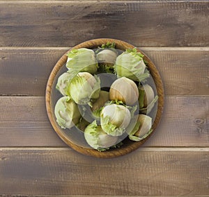 Fresh hazelnuts on wooden background. Hazelnuts in a bowl with copy space for text. Hazelnut close-up on rustic table.