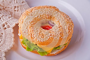 Fresh healthy bagel sandwich on a white plate