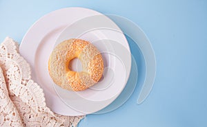 Fresh healthy bagel on a white plate. Top view.