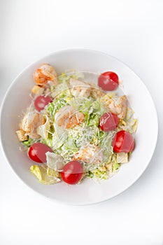 Fresh healthy caesar salad with chicken on white background. Top view. Selective focus