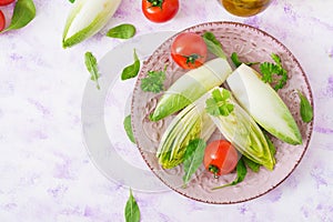 Fresh and healthy Chicory witloof Salad and tomato on a plate.