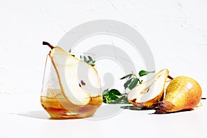 Fresh and healthy cocktail or mocktail with pear, ice and herbs on white background. Refreshing summer vitamin drink.