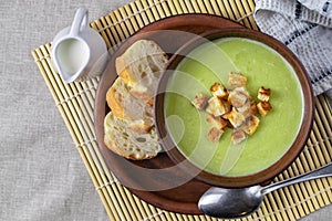 Fresh healthy cream soup with spinach, cream and croutons