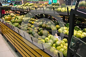 Fresh healthy fruits on shelves in supermarket