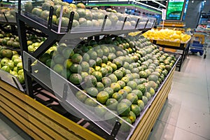 Fresh healthy fruits on shelves in supermarket