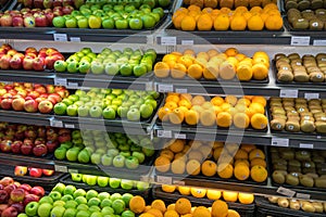 Fresh healthy fruits on shelves in supermarket