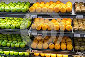 Fresh healthy fruits on shelves in supermarket