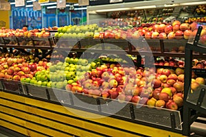 Fresh healthy fruits on shelves in supermarket