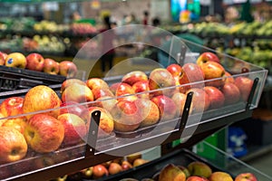 Fresh healthy fruits on shelves in supermarket