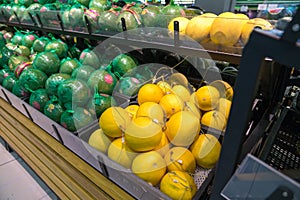 Fresh healthy fruits on shelves in supermarket