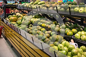 Fresh healthy fruits on shelves in supermarket