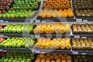 Fresh healthy fruits on shelves in supermarket