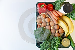 Fresh healthy groceries and vegetables from supermarket in green tray box. Food delivery service